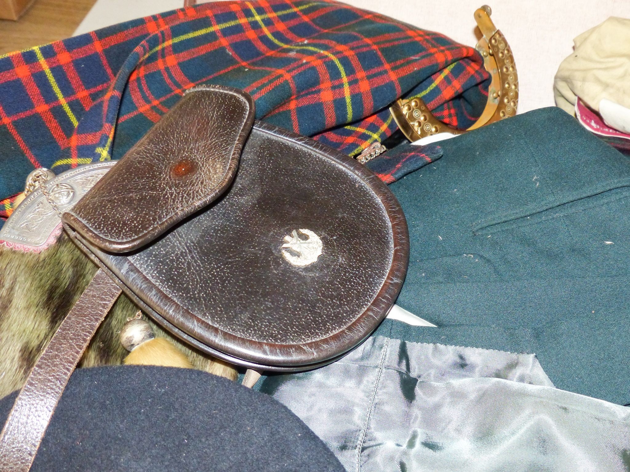 A group of early 20th century men’s and women’s tartan clothing, a electroplate mounted sporran etc.